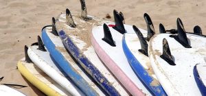 Surf boards piled up on the beach, Bay of Islands